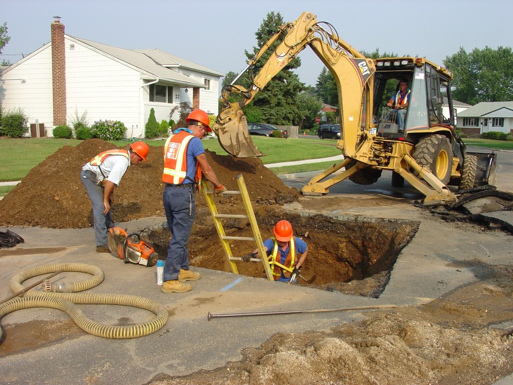 Hicksville Water District employees repair water main pipes in the summer. Beginning this fall 2015, more than 20,000 feet of cast iron pipe will be replaced with stronger, more flexible ductile iron pipe.